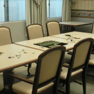 An empty conference room with a large table and multiple chairs.
