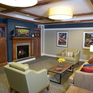 A cozy living room with comfortable seating, a fireplace, and modern decor.