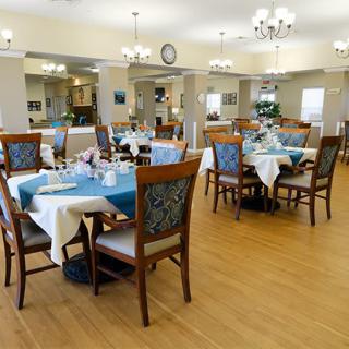 An elegant dining room with neatly arranged tables and chairs.