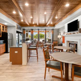 A beautifully designed modern kitchen and dining area featuring wooden ceilings and ample natural light.