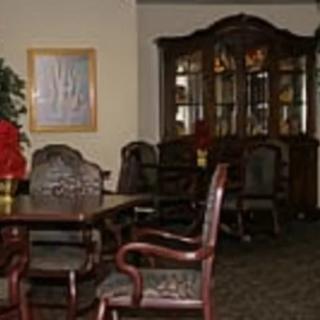 A traditional dining room with a wooden table, chairs, and a china cabinet.