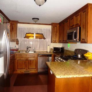 A cozy kitchen with wooden cabinets and stainless steel appliances.