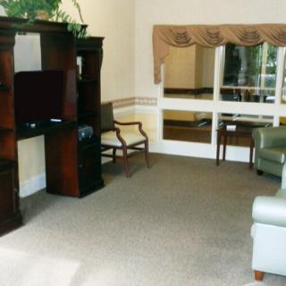 A cozy living room with comfortable seating and a wooden entertainment center.