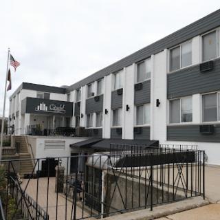 An exterior view of a hotel featuring modern architecture and multiple windows.