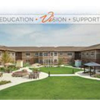 A modern educational facility surrounded by landscaped grounds.