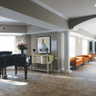 A modern lobby with a grand piano, stylish seating, and contemporary artwork.