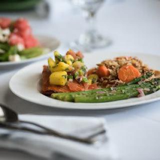 A beautifully arranged plate featuring a healthy mix of vegetables and grains, with asparagus in the foreground.