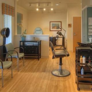 A modern hair salon interior with styling chairs and equipment.