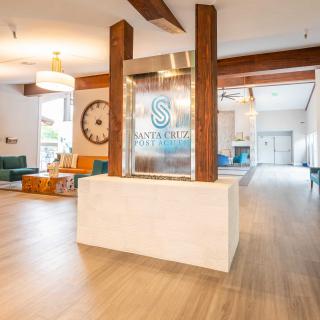 A modern lobby with stylish decor, featuring wooden beams and comfortable seating.