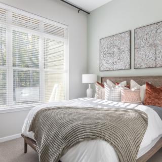 A cozy modern bedroom with stylish decor and ample natural light.