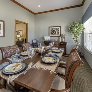 A beautifully arranged dining room with a set table and elegant decor.