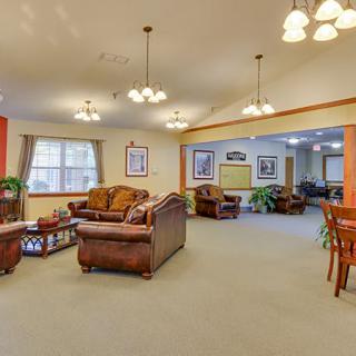 A spacious living room with comfortable sofas and warm lighting.