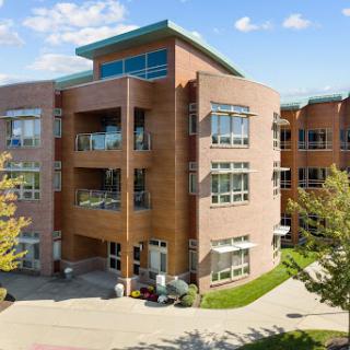 A modern residential building featuring a brick facade and ample natural light.