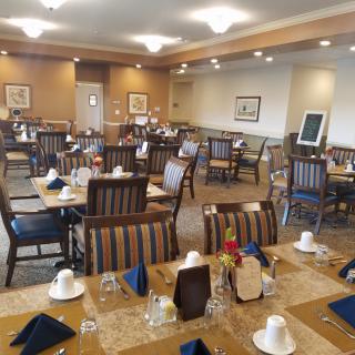 A neatly arranged dining room with tables set for service.
