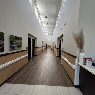 A spacious and modern hallway with well-lit interiors and decorative elements.
