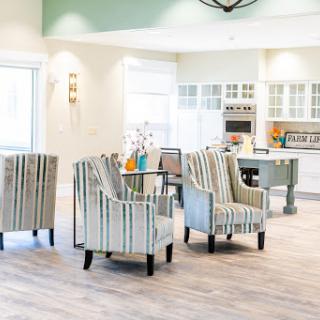 A bright and modern living space featuring stylish striped chairs and a cozy atmosphere.
