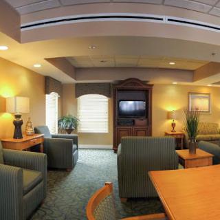 A cozy living room space featuring comfortable seating and a warm atmosphere.