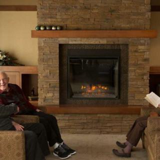 People relaxing by a fireplace in a cozy living room.