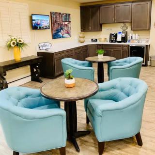 A cozy lounge area with modern furnishings and a coffee station.