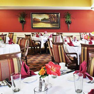 A well-decorated restaurant dining room with tables set for guests.