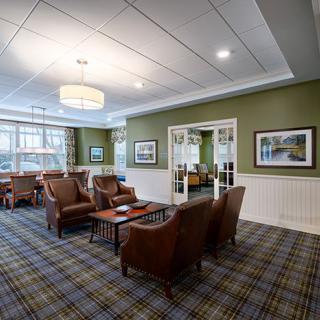 A cozy lounge area with armchairs and traditional decor.