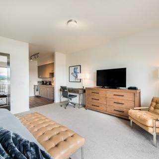 A modern living room featuring a television, sofa, and elegant decor.