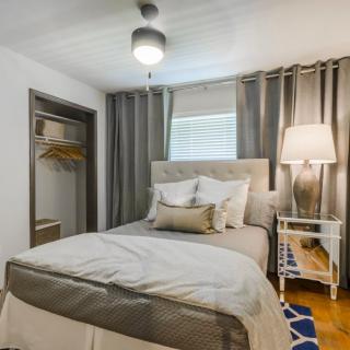 Cozy bedroom with neutral tones and modern decor.