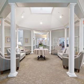 A modern lobby area with elegant seating and architectural columns.