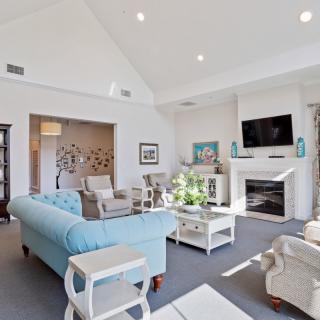 A spacious and modern living room with a cozy fireplace and elegant decor.