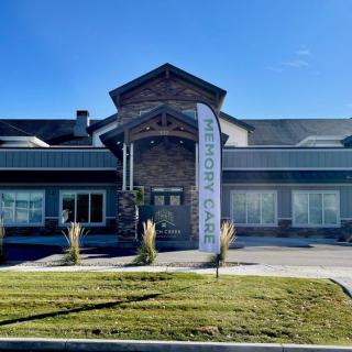 A modern commercial building with a well-maintained landscape on a sunny day.