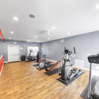 A well-equipped gym featuring various exercise machines and a modern design.