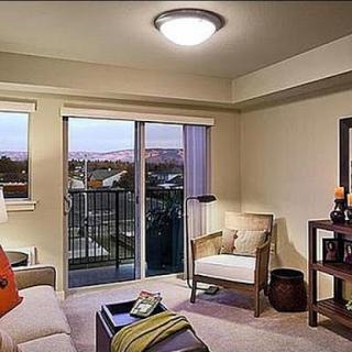A cozy living room featuring a modern design with a balcony view.