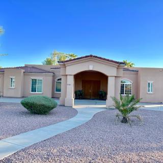 A beautiful residential home showcasing modern architecture and a welcoming front yard.