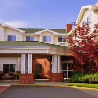 A residential building with a welcoming entrance and landscaped surroundings.