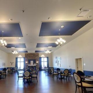 A spacious dining room with elegant furniture and modern lighting.