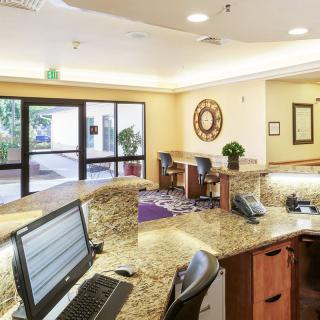 A modern reception desk with computers in a business office lobby.