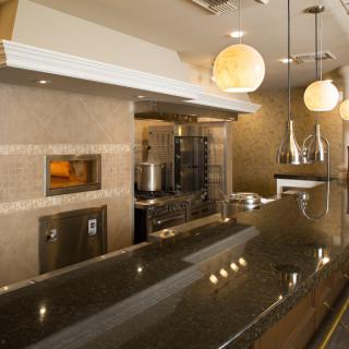 Modern restaurant kitchen interior with sleek design and ambient lighting.