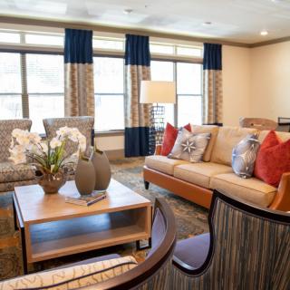 A cozy living room with stylish decor, featuring comfortable sofas and a well-arranged coffee table.