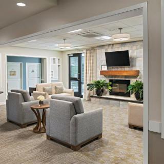 A modern living room with comfortable seating, a fireplace, and a television.