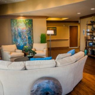 A modern and cozy living room with comfortable seating and vibrant artwork.