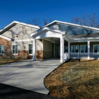 A suburban residential house with a driveway and front yard.