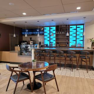 A modern cafe interior featuring a stylish bar counter and comfortable seating.