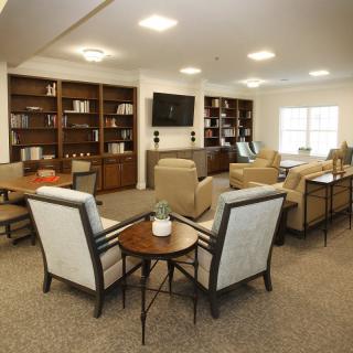 A cozy lounge area with comfortable seating and bookshelves.