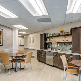 A modern break room with kitchen facilities and seating area.