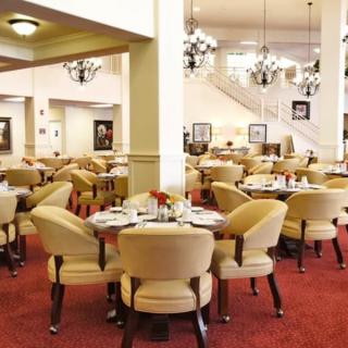 Elegant restaurant interior with empty tables and plush seating.