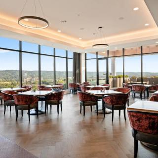 A spacious restaurant dining area with large windows offering a scenic view.