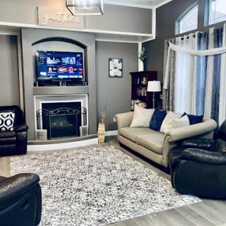 A stylish and cozy living room featuring a blend of modern furniture and warm colors.