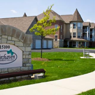 A sunny day showcasing an apartment complex with well-maintained landscaping.