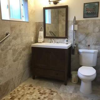 Modern bathroom with a tiled design and dark wood vanity.