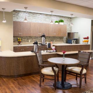 A cozy and modern kitchen area featuring a small dining table and coffee station.